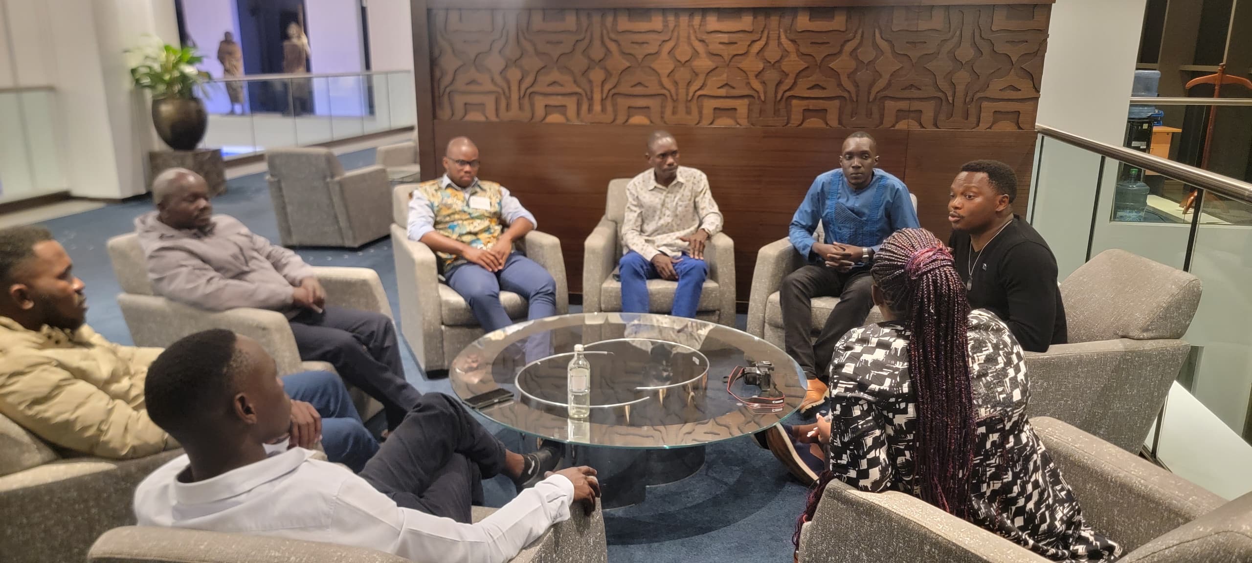 Leonard posing with participants backstage after an event